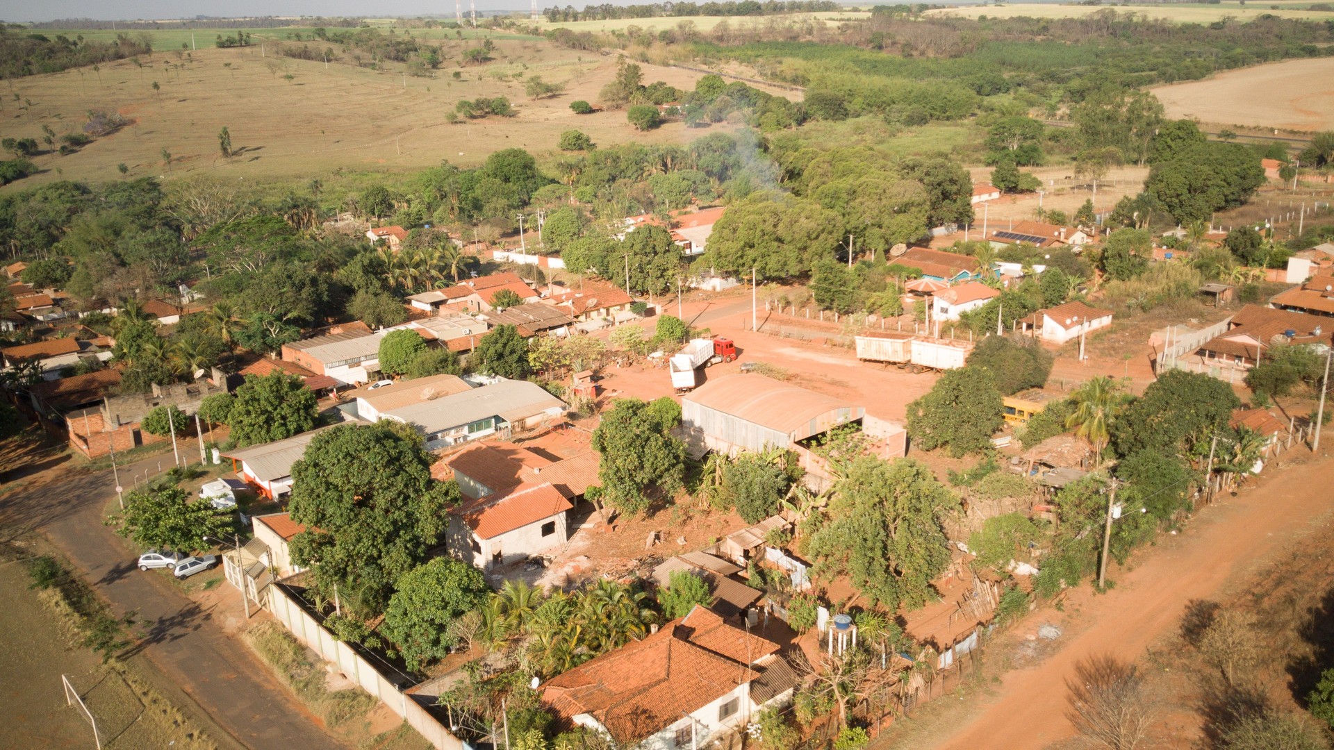 Aerial drone view of the rural neighborhood of Ibitu in Barretos, São Paulo, Brazil with general view of the church, football field and houses during sunny day
